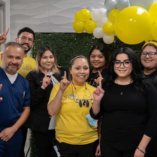 The Soleil team celebrating with yellow balloons at the office opening