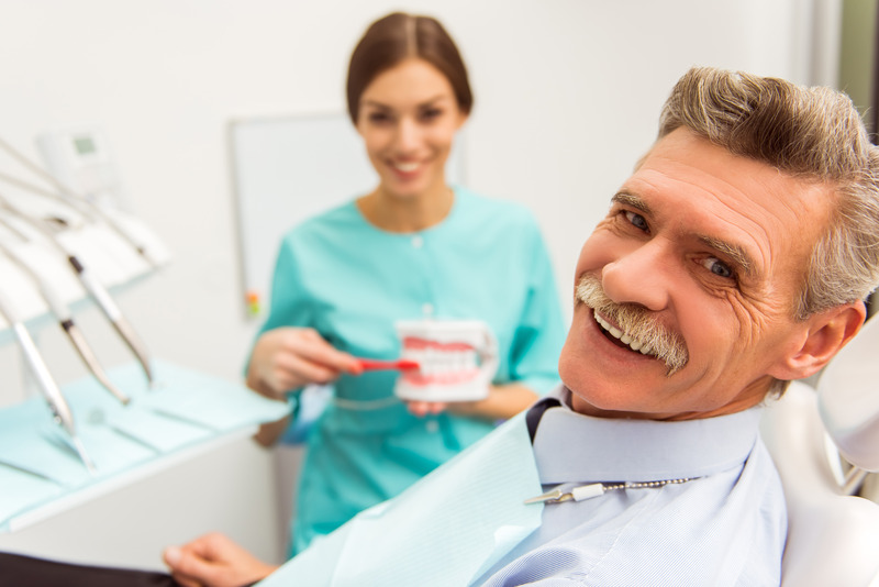 Older patient smiling with dental implants